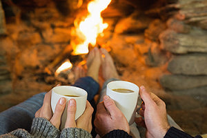 people wearing heated clothing and sitting near a fire